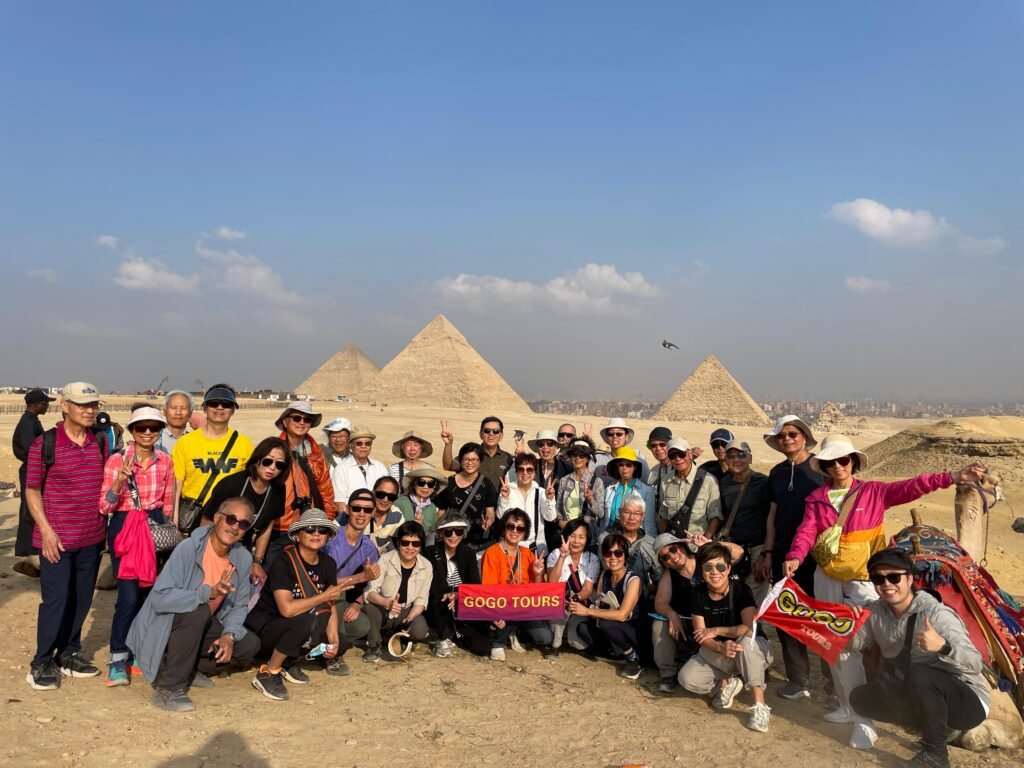 Group of GoGo Tours tourists at the Pyramids of Giza Egypt