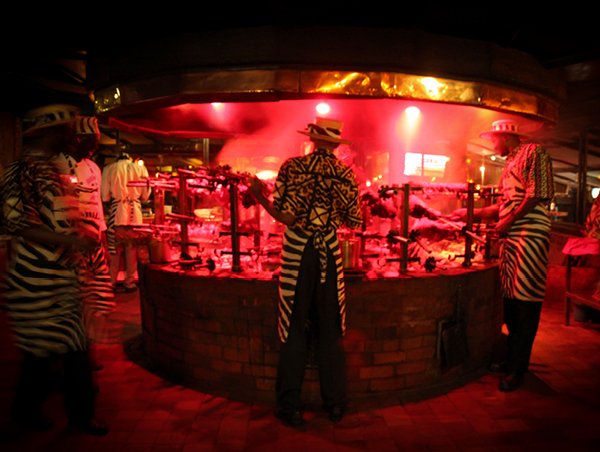 Chefs grilling meat at Nairobi's Carnivore Restaurant.