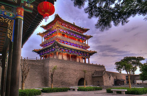 Illuminated gate tower in Pingyao Ancient City at dusk