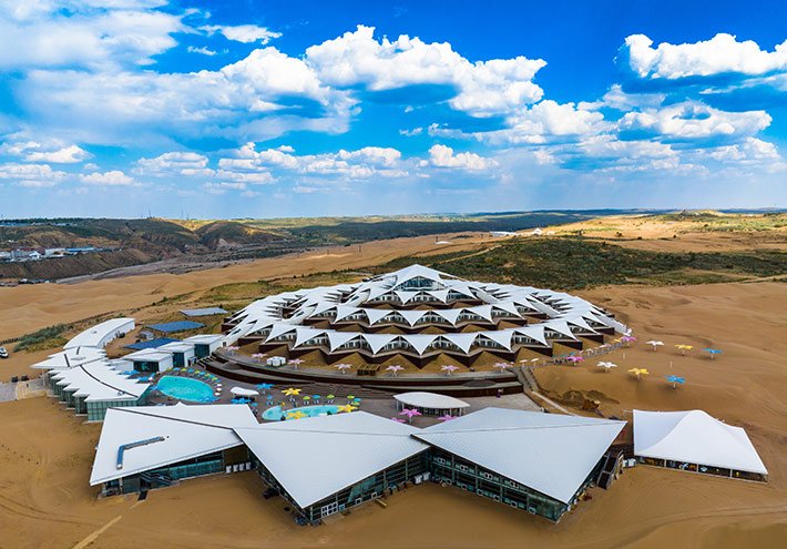 Lotus Resort buildings surrounded by sand dunes at Xiangshawan Whistling Dune Bay