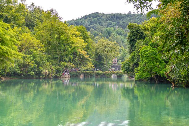 Tranquil lake surrounded by lush forest in Libo.
