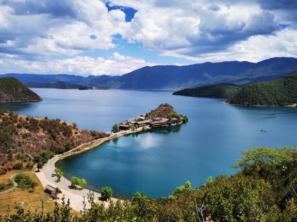 Scenic view of Lugu Lake with surrounding mountains.