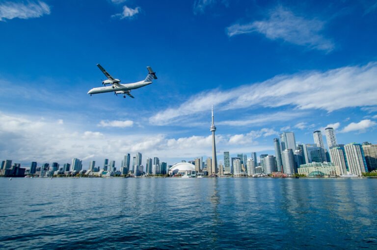 Airplane flying over Toronto skyline with CN Tower