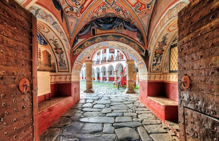 Ornate entrance with frescoes at Rila Monastery.