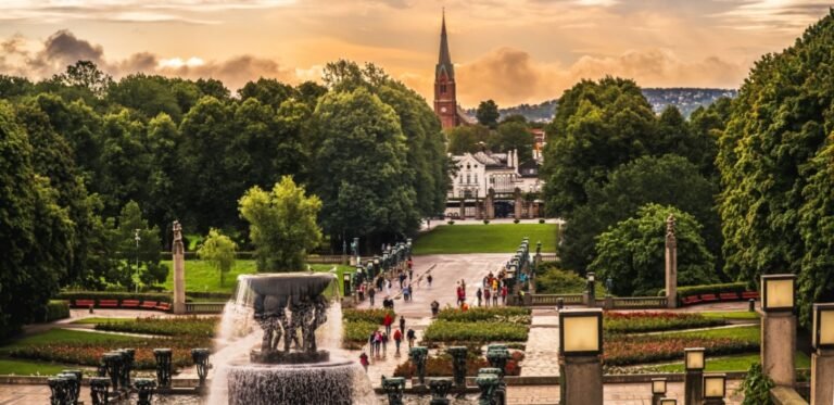 Vigeland Park fountain with church in Oslo