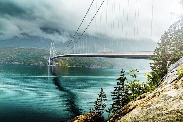 Hardanger Bridge over a misty fjord in Norway
