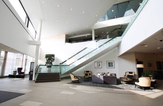 Modern hotel lobby with staircase and seating area