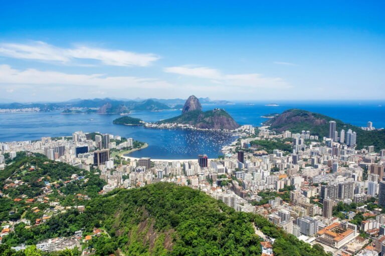 Aerial view of Rio de Janeiro with Sugarloaf Mountain in the background.